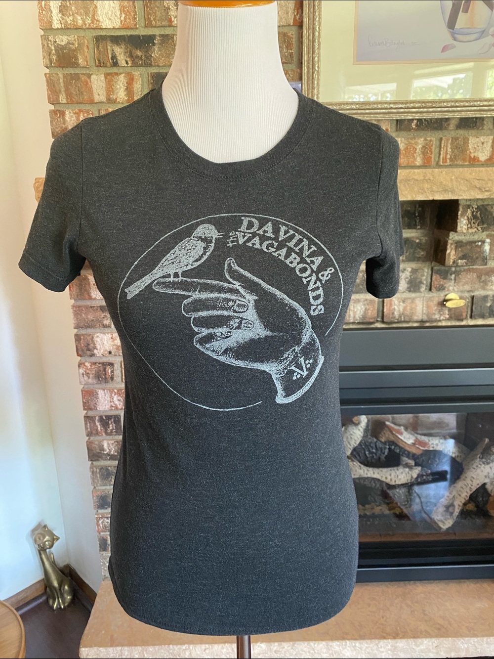 DAVINA & THE VAGABONDS tshirt. Gray and white with hand and bird logo image.